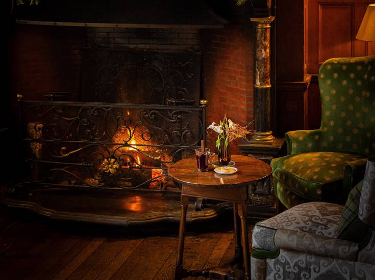 By the fire in the front hall